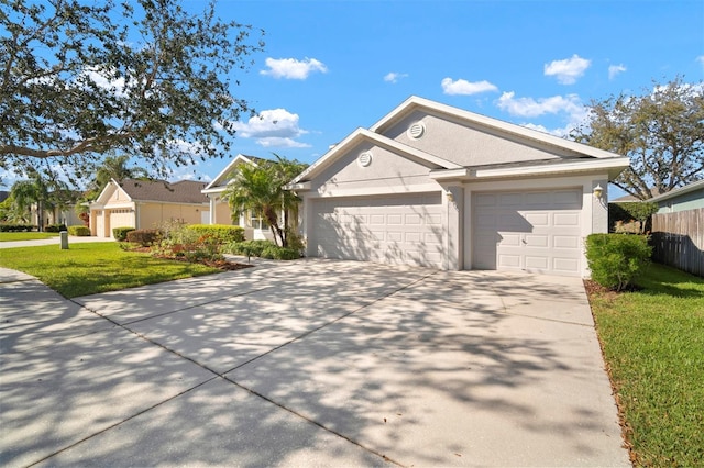 view of front facade featuring stucco siding, driveway, a front lawn, fence, and an attached garage