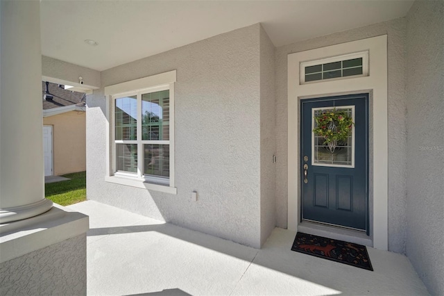 doorway to property with stucco siding