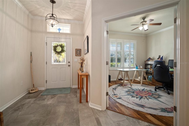 foyer featuring plenty of natural light, ceiling fan with notable chandelier, crown molding, and baseboards