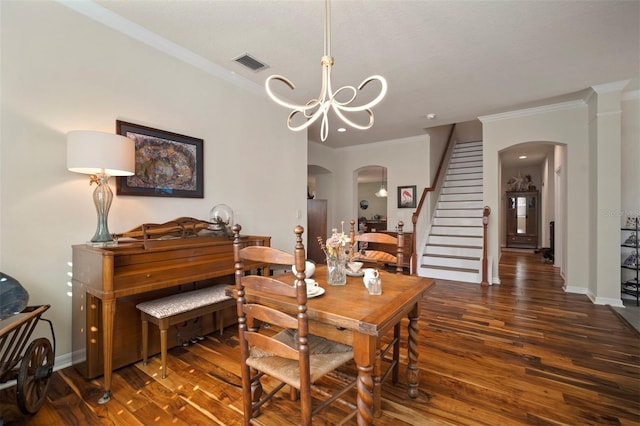 dining space featuring arched walkways, visible vents, stairway, and a chandelier