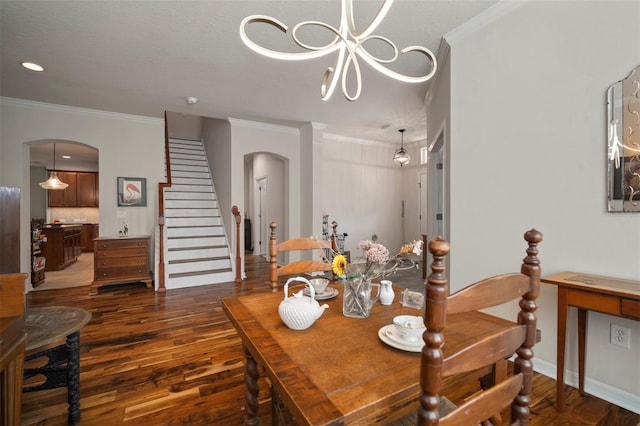 dining room with arched walkways, dark wood-type flooring, and crown molding