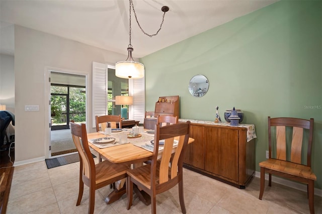 dining room with light tile patterned floors and baseboards