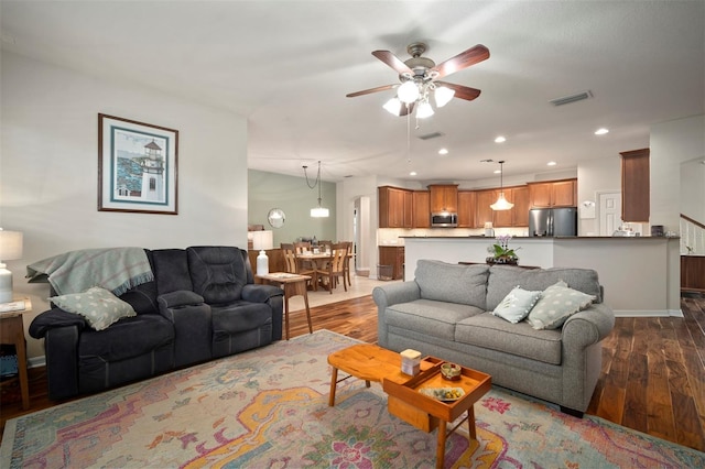 living area with visible vents, a ceiling fan, wood finished floors, recessed lighting, and baseboards