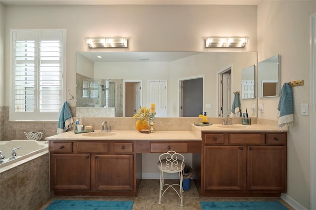 full bath featuring a sink, a stall shower, double vanity, and a bath