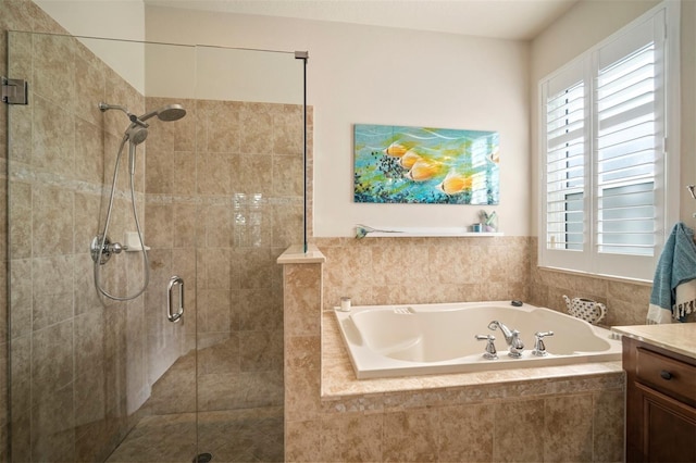 bathroom with vanity, a bath, and a stall shower