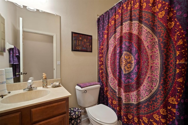 bathroom with vanity, curtained shower, and toilet