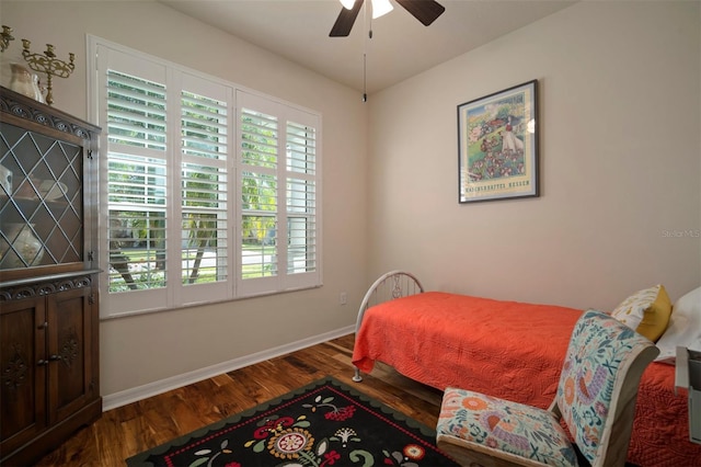 bedroom with a ceiling fan, baseboards, and wood finished floors