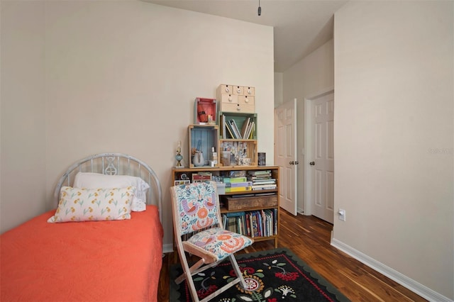 bedroom featuring wood finished floors and baseboards