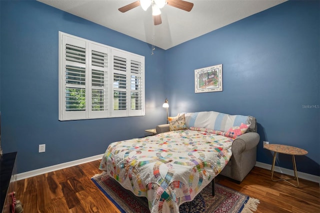 bedroom featuring ceiling fan, baseboards, and wood finished floors