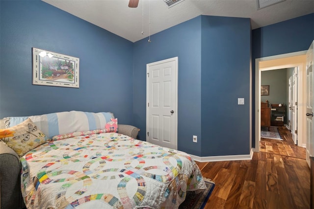 bedroom with a ceiling fan, baseboards, and wood finished floors