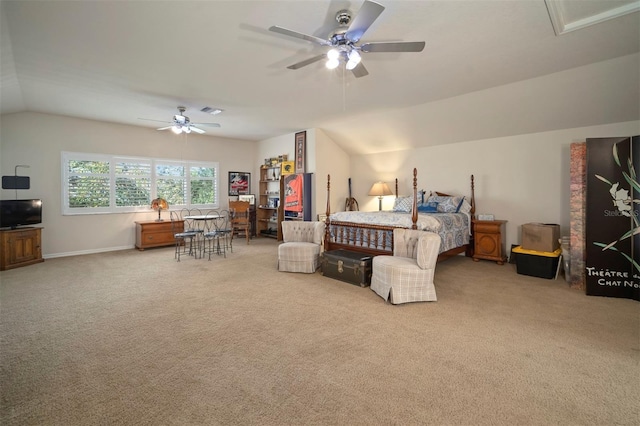 carpeted bedroom with vaulted ceiling, a ceiling fan, and visible vents