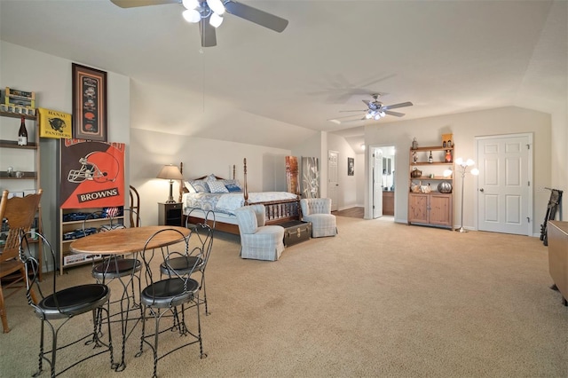 bedroom with a ceiling fan, vaulted ceiling, and carpet