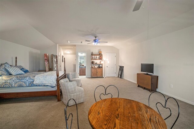 bedroom featuring light colored carpet, ceiling fan, baseboards, and vaulted ceiling