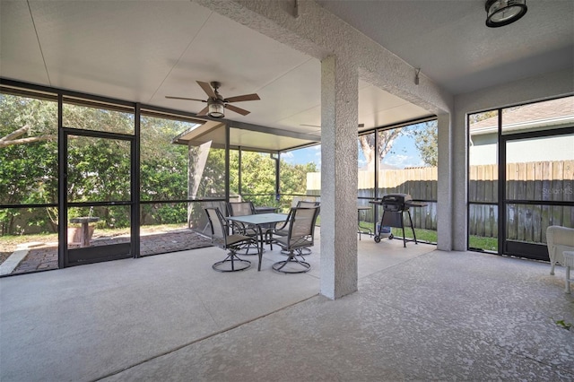 sunroom featuring a ceiling fan