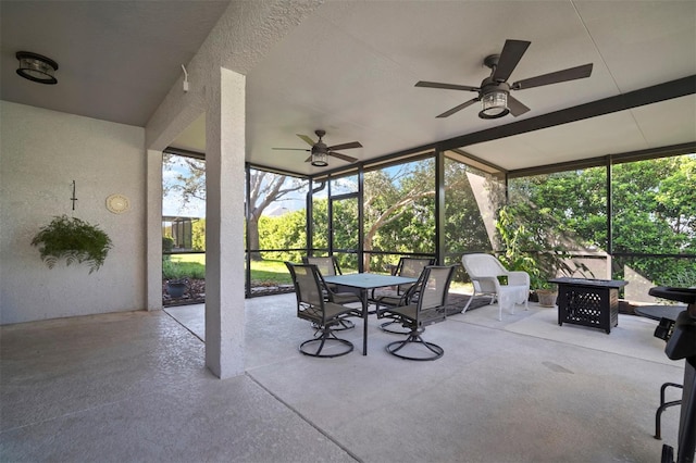 view of patio / terrace with a lanai, outdoor dining space, and a ceiling fan