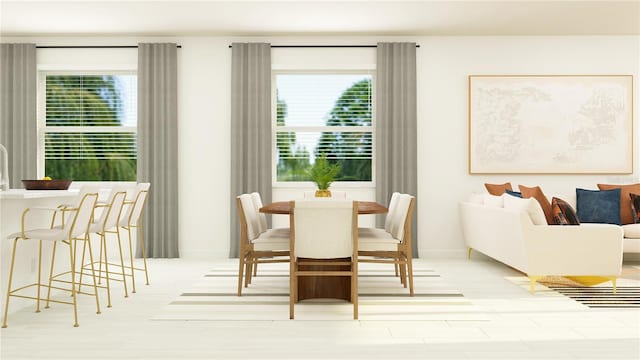 dining area featuring wood finished floors and baseboards