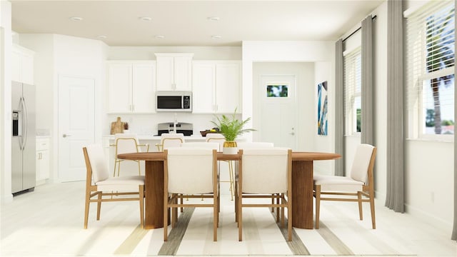 kitchen with a center island with sink, white cabinetry, white fridge with ice dispenser, stainless steel stove, and light countertops