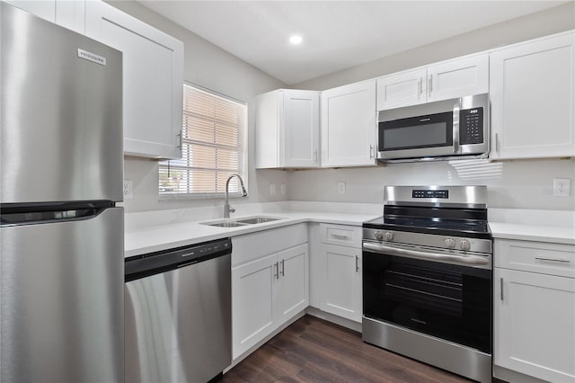 kitchen with a sink, appliances with stainless steel finishes, white cabinets, and light countertops