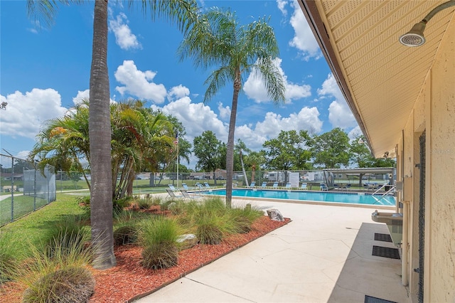 pool featuring a patio area and fence