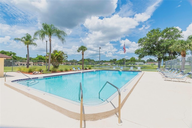 pool featuring a patio and fence