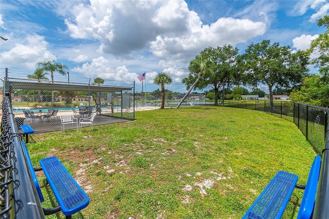 view of yard with a community pool and fence