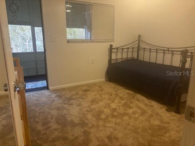 bedroom with carpet and baseboards