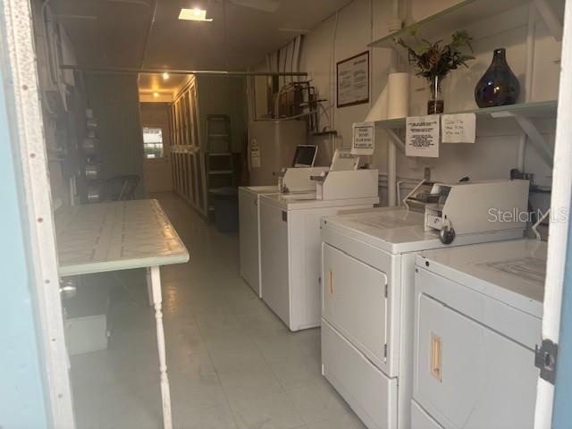 community laundry room featuring water heater and independent washer and dryer