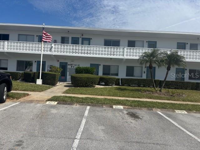 view of building exterior featuring uncovered parking