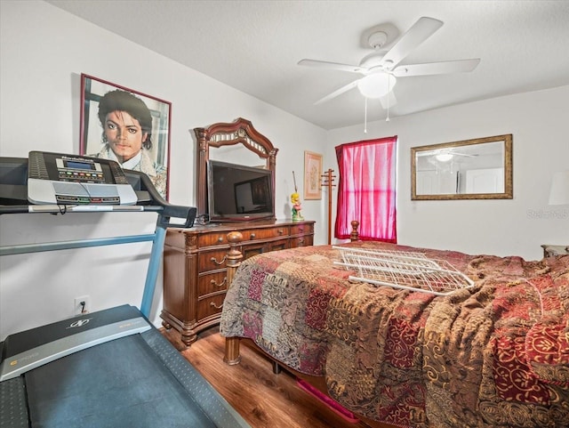 bedroom with ceiling fan and wood finished floors