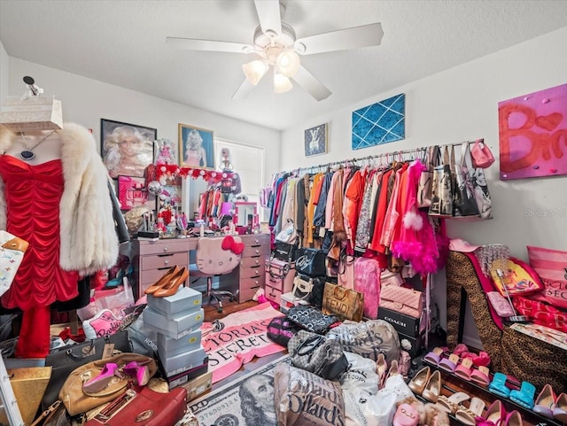 walk in closet with a ceiling fan