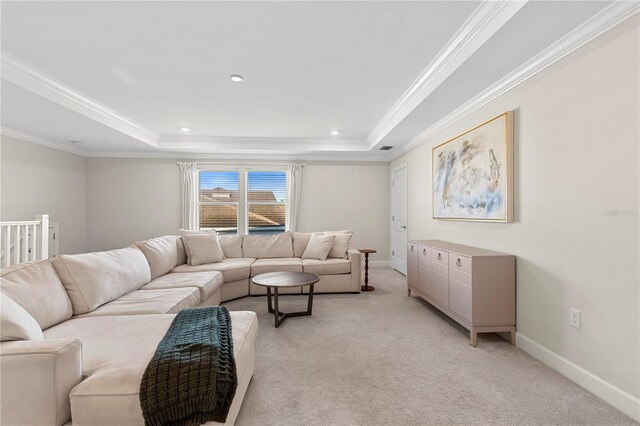 living room featuring light colored carpet, a raised ceiling, crown molding, and baseboards