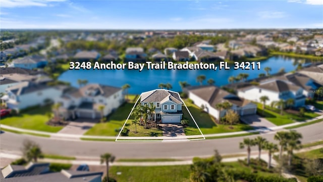 birds eye view of property featuring a water view and a residential view