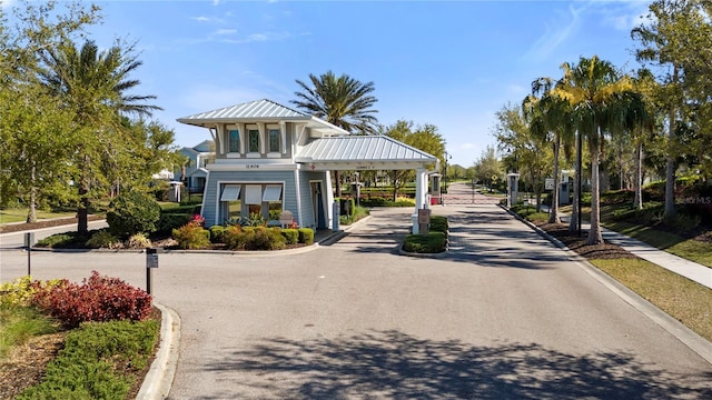 view of road with curbs and a gated entry