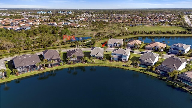 drone / aerial view with a residential view and a water view