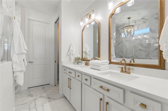 bathroom featuring double vanity, a sink, marble finish floor, and a chandelier