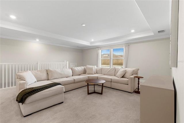 living area featuring light carpet, a raised ceiling, recessed lighting, visible vents, and ornamental molding