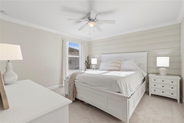 bedroom featuring ceiling fan, light colored carpet, ornamental molding, and baseboards