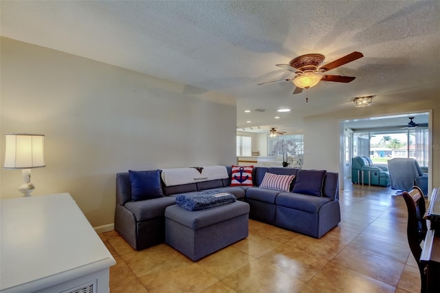 living area featuring light tile patterned flooring and a textured ceiling