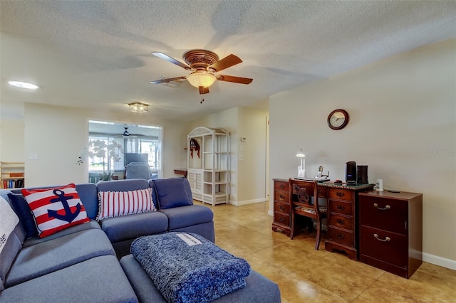 living room featuring baseboards, light tile patterned floors, a textured ceiling, and ceiling fan