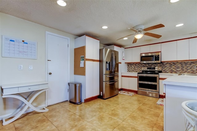 kitchen featuring white cabinetry, light countertops, backsplash, and stainless steel appliances