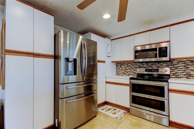 kitchen with backsplash, stainless steel appliances, light countertops, and ceiling fan