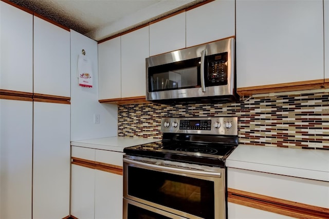 kitchen with white cabinetry, tasteful backsplash, appliances with stainless steel finishes, and light countertops