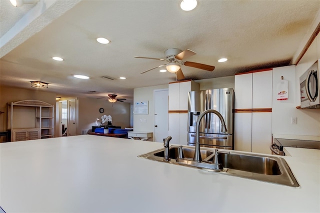 kitchen with visible vents, recessed lighting, stainless steel appliances, a textured ceiling, and a sink