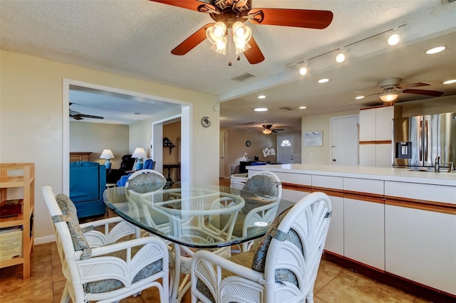 dining space featuring light tile patterned floors, recessed lighting, visible vents, and a textured ceiling