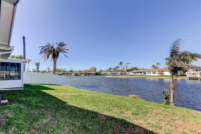 view of yard with fence and a water view