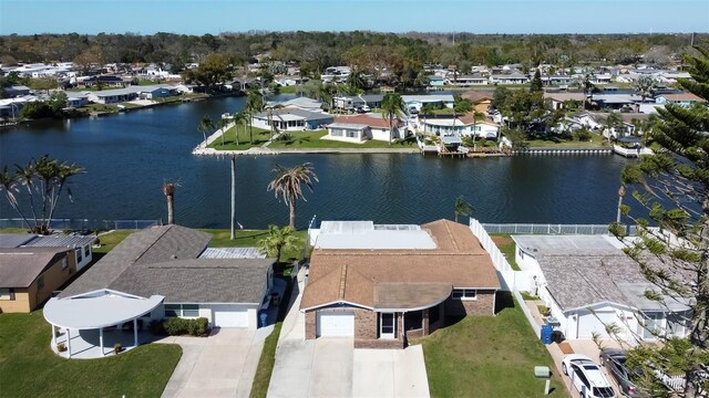 drone / aerial view with a residential view and a water view