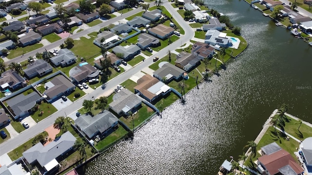 drone / aerial view with a residential view and a water view