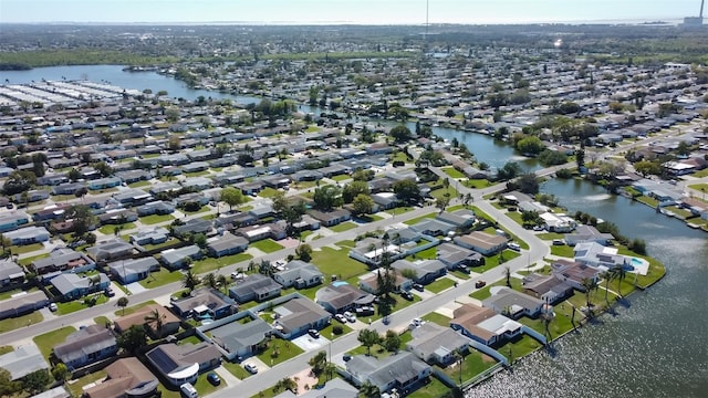 drone / aerial view featuring a residential view and a water view