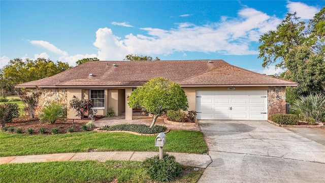 single story home featuring stucco siding, concrete driveway, a front lawn, a garage, and stone siding