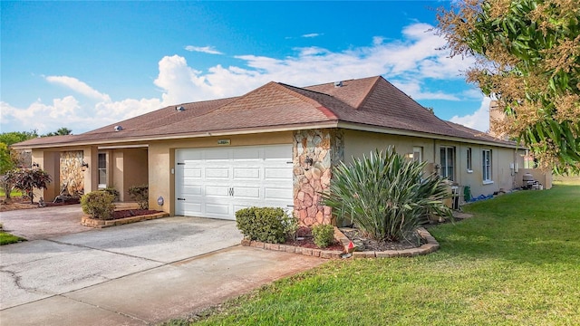 ranch-style house featuring concrete driveway, a front yard, stucco siding, a garage, and stone siding